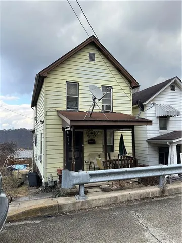 a view of a house with a balcony and large windows