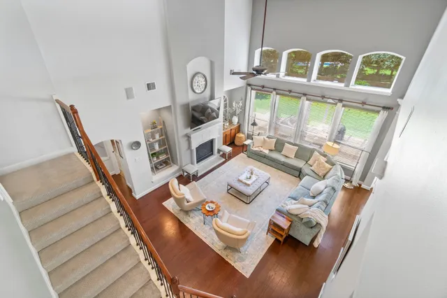 a living room with furniture and a floor to ceiling window