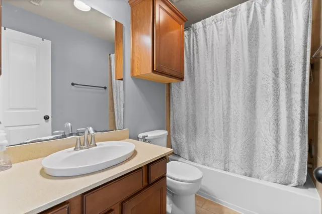 a bathroom with a sink toilet and a mirror