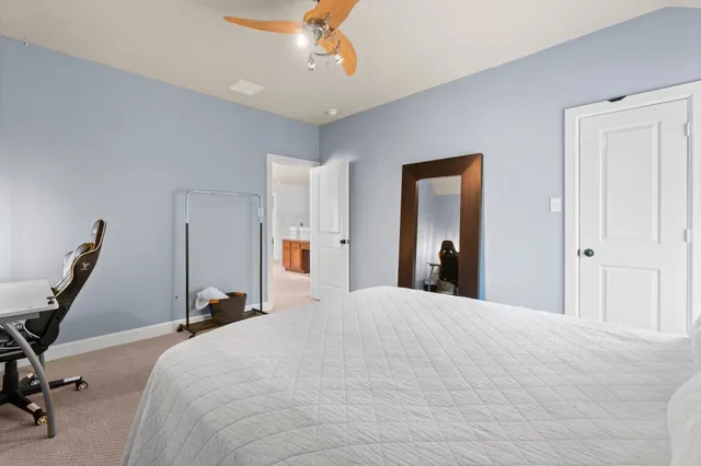 a bedroom with a bed a desk and chair