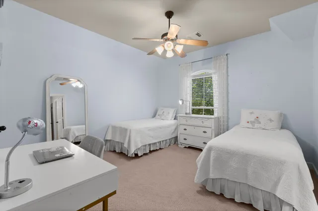 a bedroom with two beds and a table