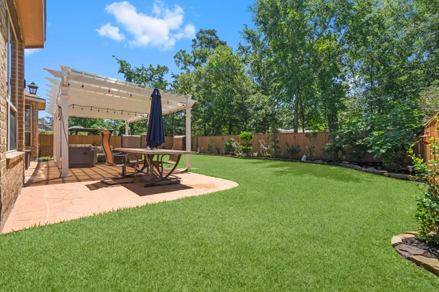 a view of a backyard with sitting area and garden