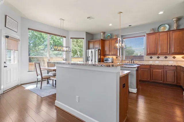 a kitchen with a sink a counter top space and stainless steel appliances