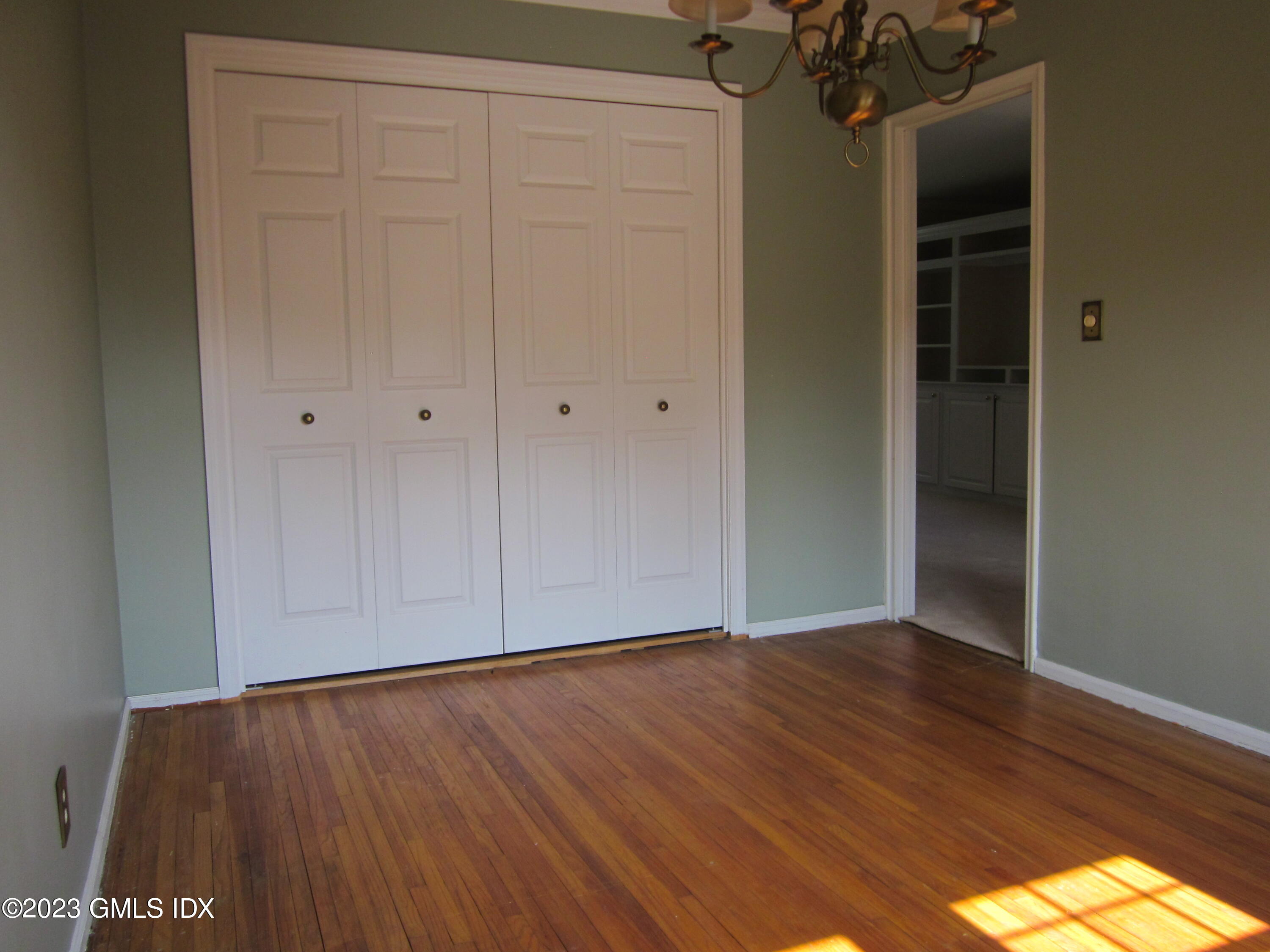 68 Putnam Park, Unit 68 Greenwich, CT 06830 - Photo 14 of 31 a view of an empty room with wooden floor and closet