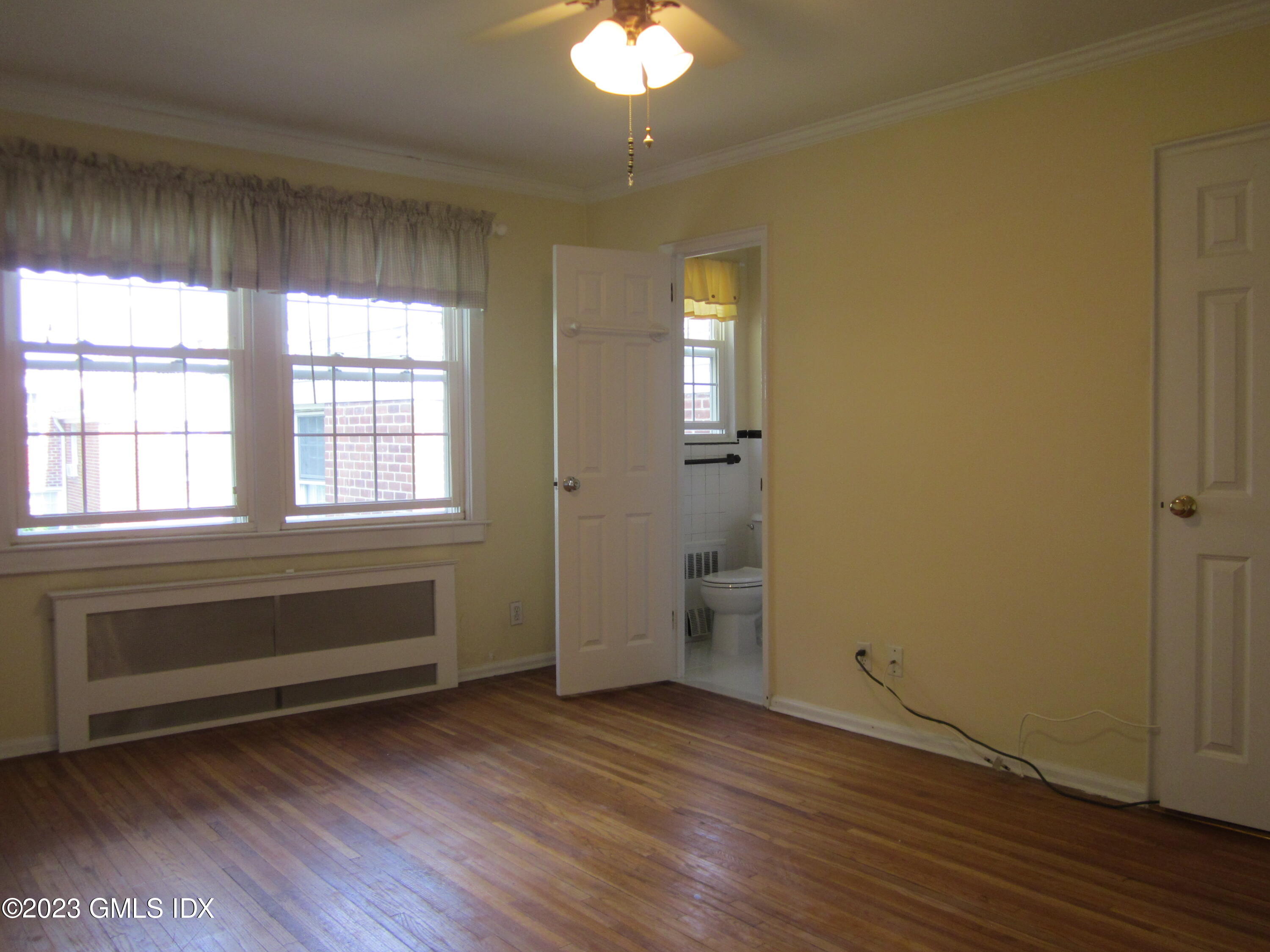 68 Putnam Park, Unit 68 Greenwich, CT 06830 - Photo 16 of 31 an empty room with wooden floor and windows