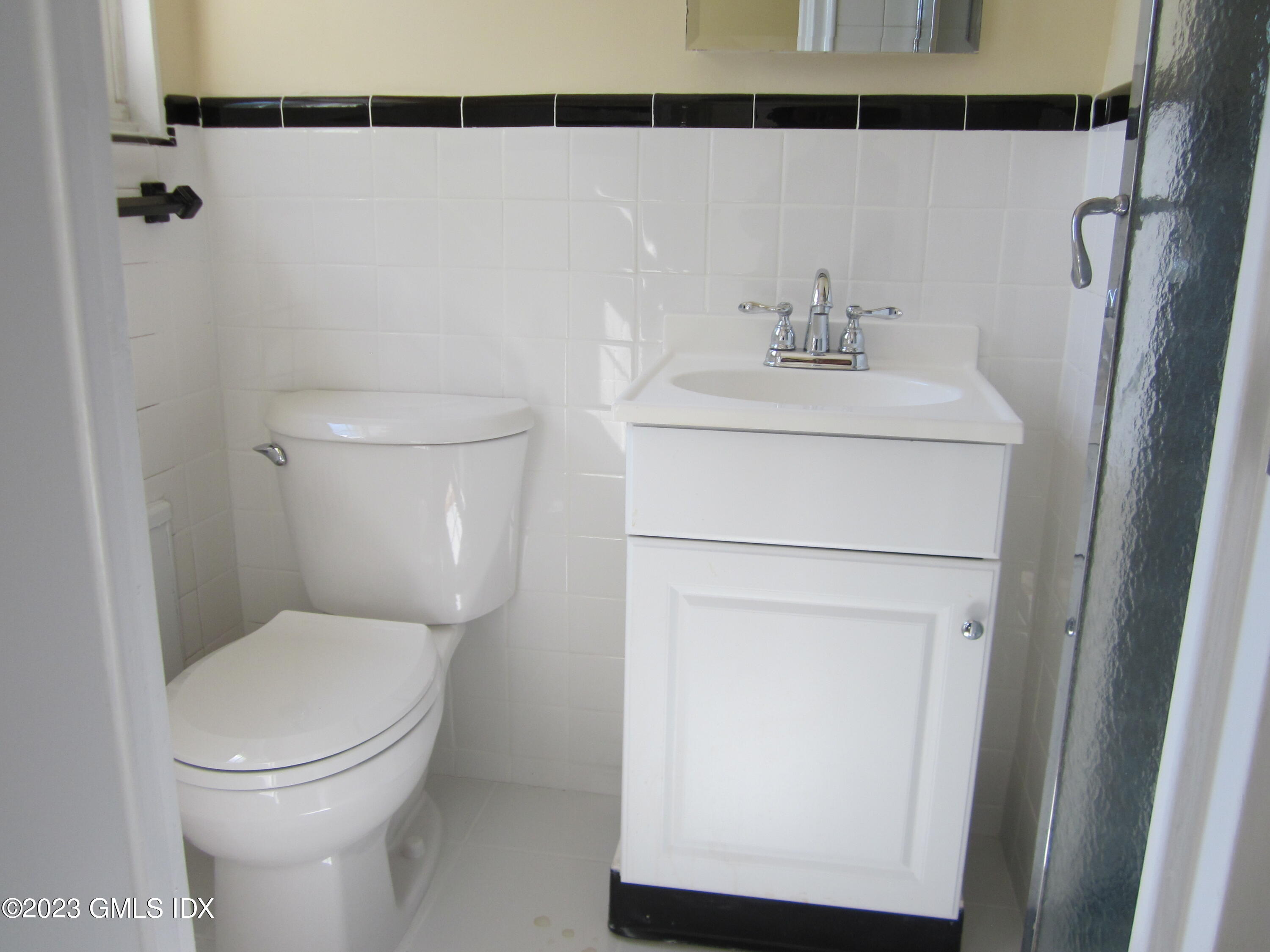 68 Putnam Park, Unit 68 Greenwich, CT 06830 - Photo 18 of 31 a bathroom with a sink a toilet and a mirror