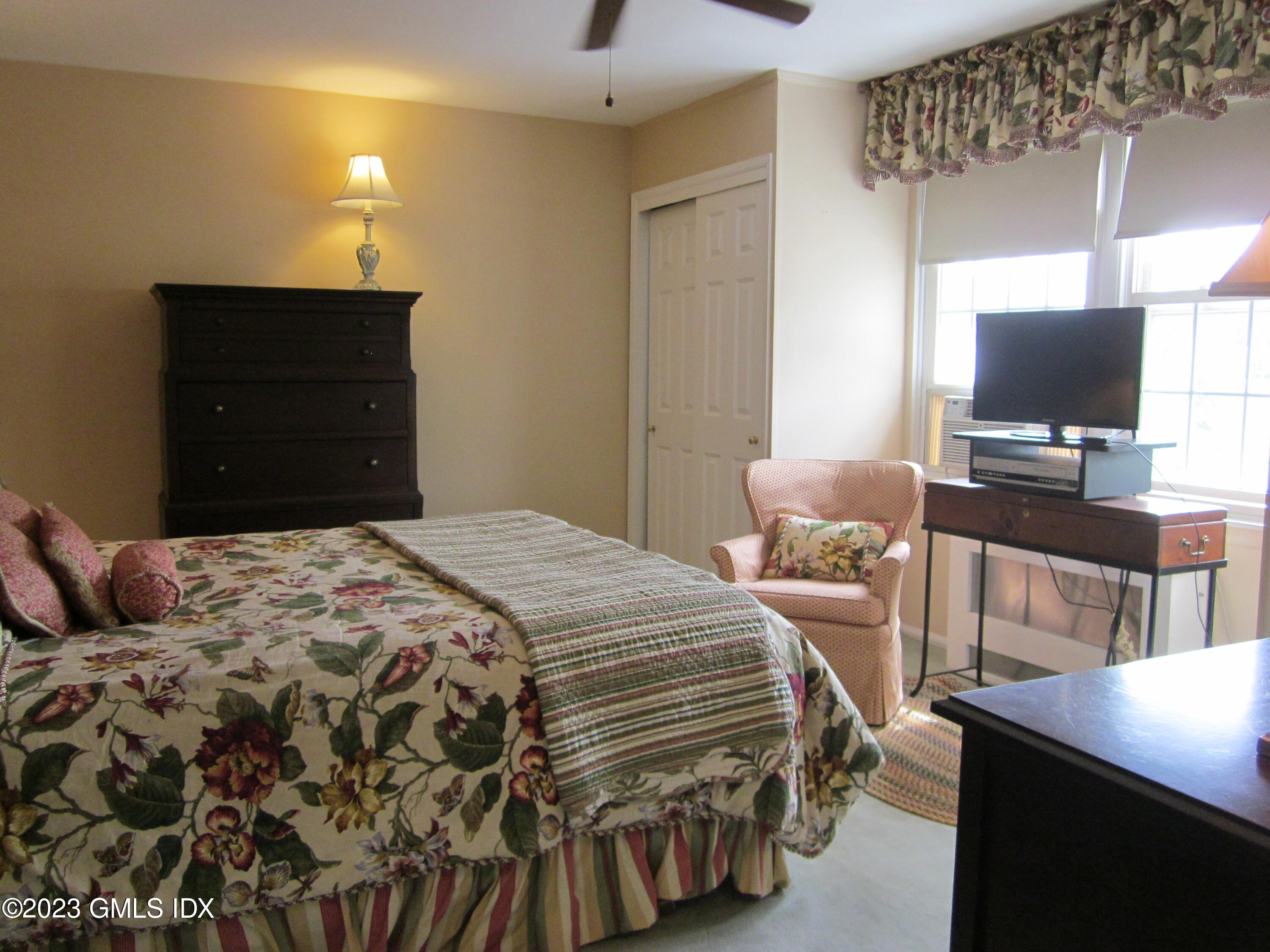 68 Putnam Park, Unit 68 Greenwich, CT 06830 - Photo 19 of 31 a bedroom with a bed and a flat screen tv