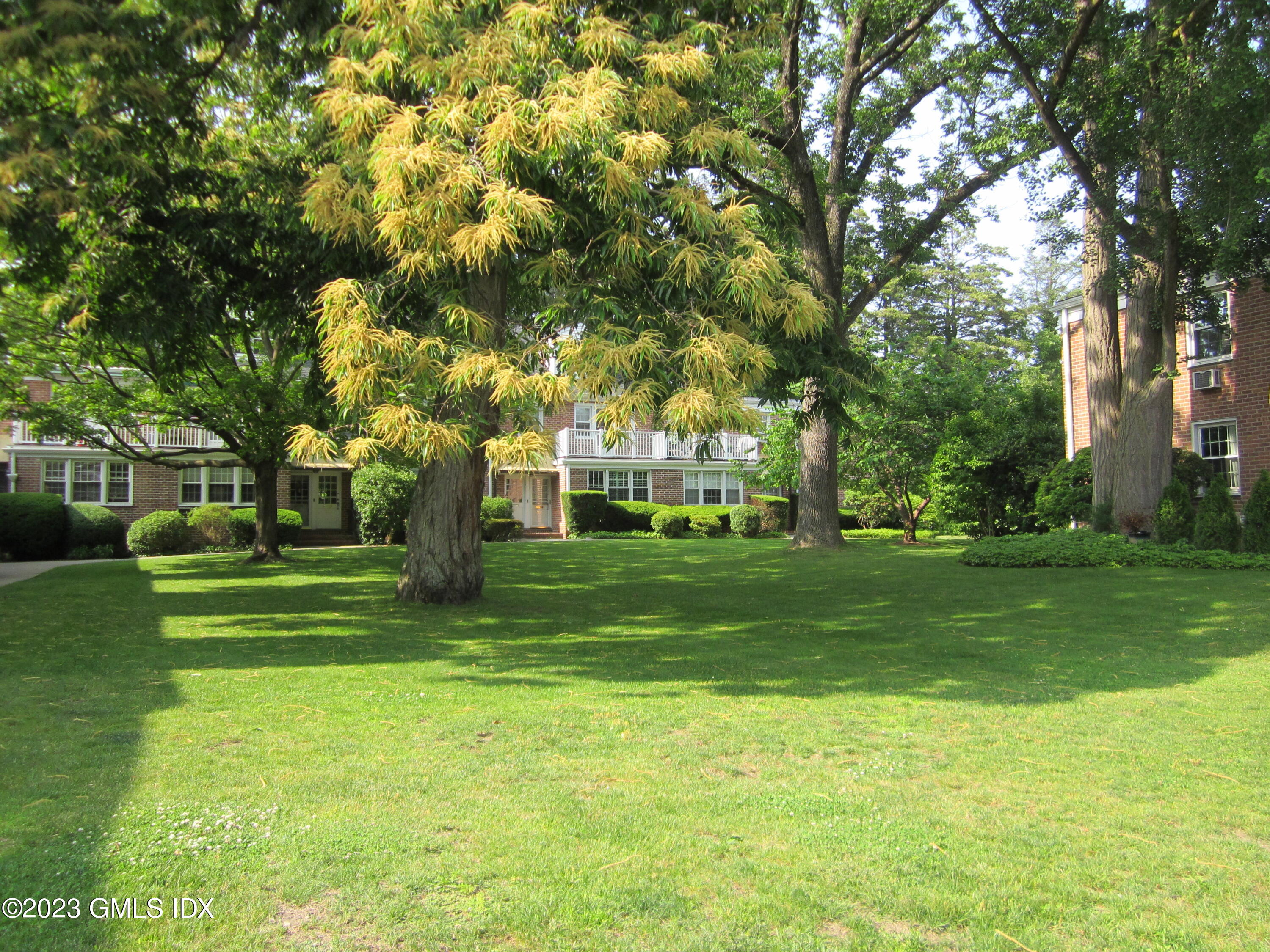 68 Putnam Park, Unit 68 Greenwich, CT 06830 - Photo 2 of 31 a view of a park with large trees
