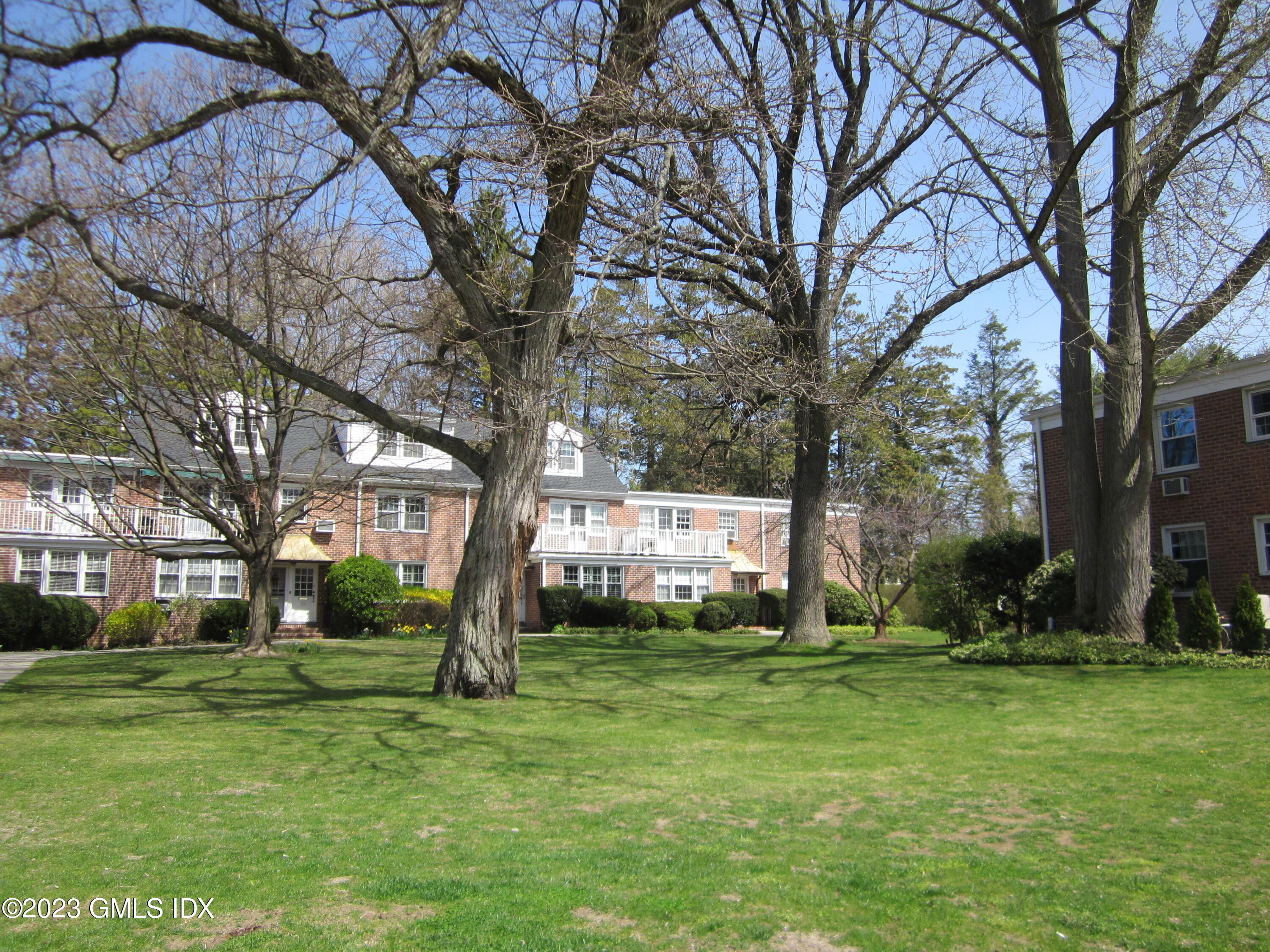 68 Putnam Park, Unit 68 Greenwich, CT 06830 - Photo 25 of 31 a view of a house with a yard