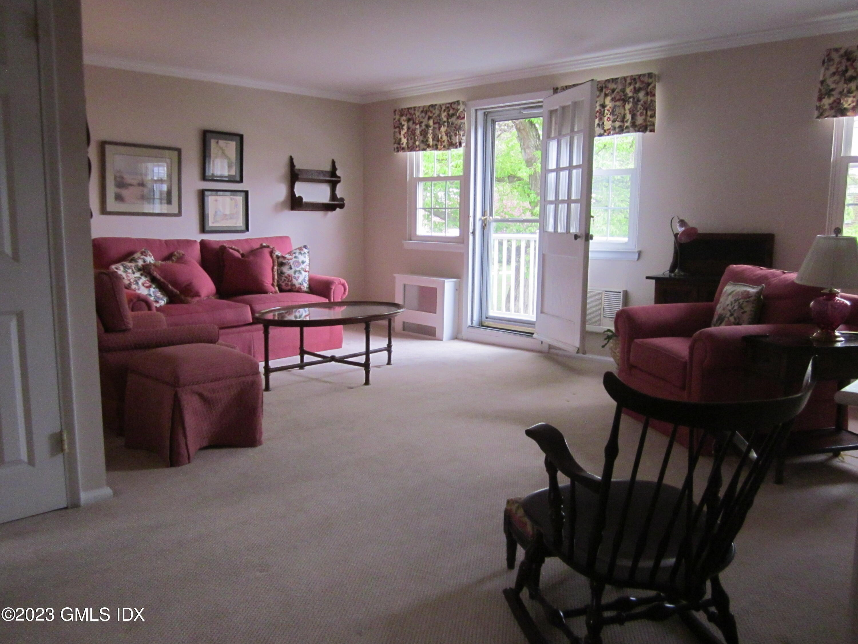 68 Putnam Park, Unit 68 Greenwich, CT 06830 - Photo 5 of 31 a living room with furniture and a large window