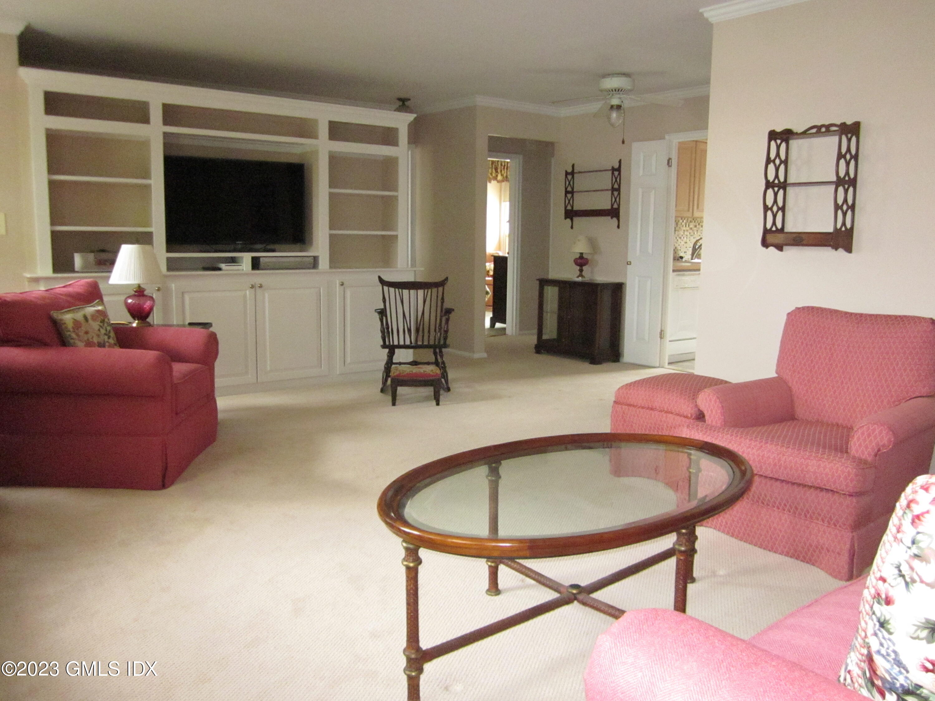 68 Putnam Park, Unit 68 Greenwich, CT 06830 - Photo 8 of 31 a living room with furniture and a flat screen tv