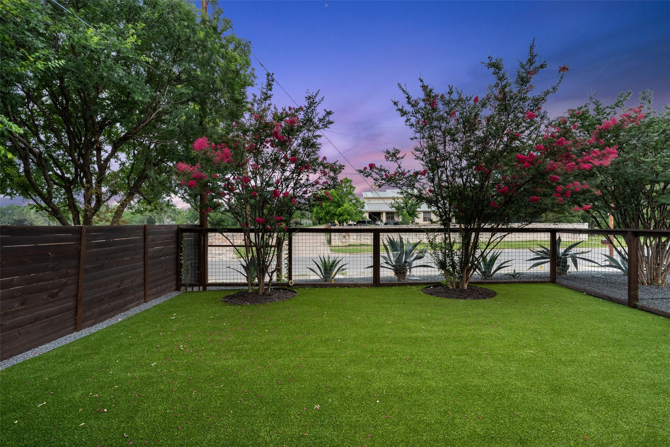 5601 Jackie Robinson Street, Unit 1 Austin, TX 78721 - Photo 40 of 40 Mature landscaping surrounds the property, while an original hitching post offers a rare nod to East Austin’s historic roots.