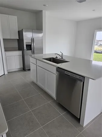 a kitchen with stainless steel appliances a sink stove and refrigerator