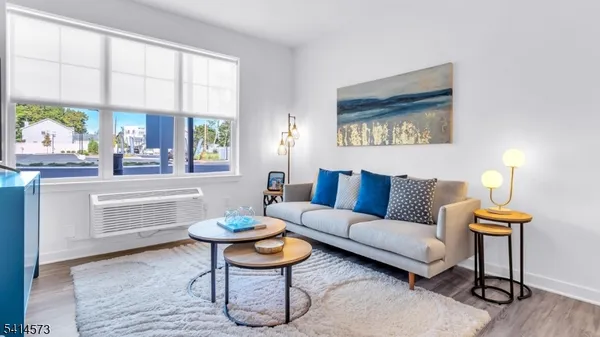 a living room with furniture a window and a table