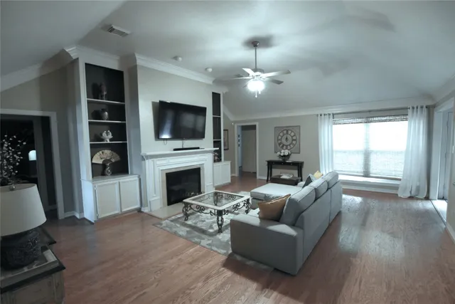 a living room with fireplace furniture and a flat screen tv