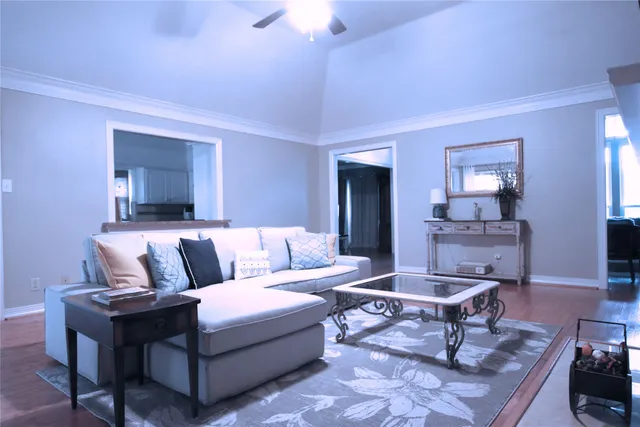 a living room with furniture and a chandelier