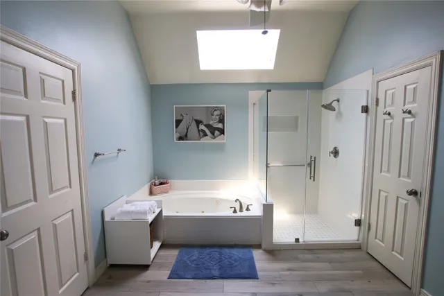 a bathroom with a bathtub and a shower
