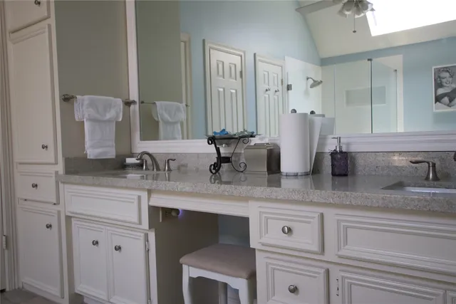 a bathroom with double sink and a mirror