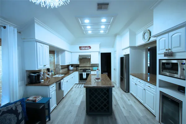 a large kitchen with stainless steel appliances lots of counter space and breakfast area