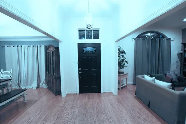 a living room with furniture and a wooden floor