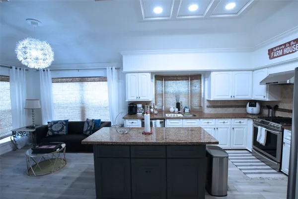 a kitchen with sink cabinets and dining table