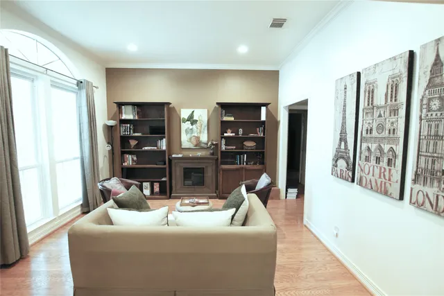 a living room with furniture kitchen view and large windows