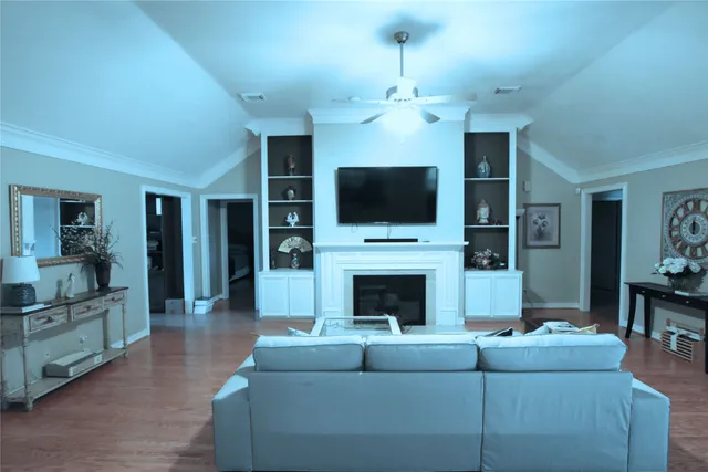a living room with furniture a flat screen tv and a fireplace