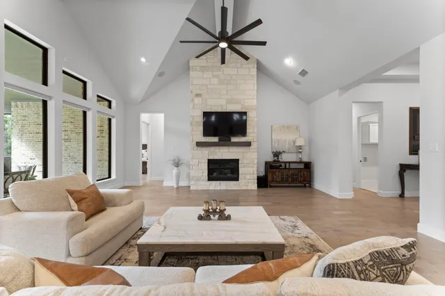 a living room with furniture a fireplace and a flat screen tv