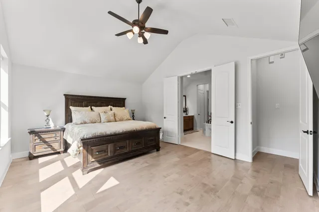 a bedroom with a bed and a chandelier