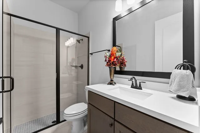 a bathroom with a sink toilet and shower