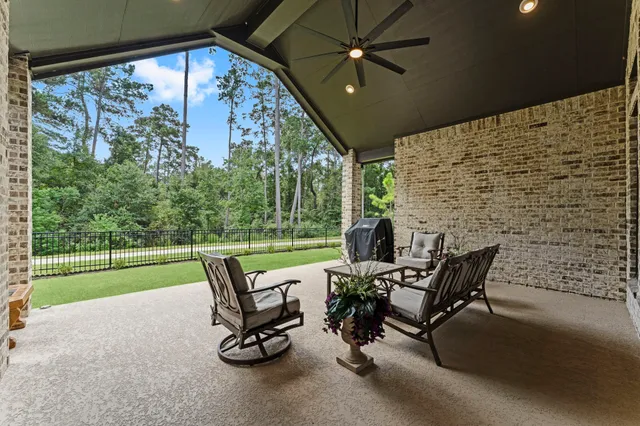 a view of a patio with a table chairs and a yard