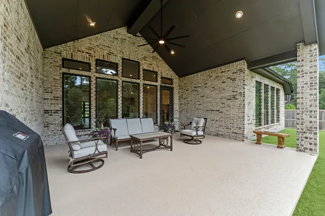 a building outdoor space with patio furniture and garden view