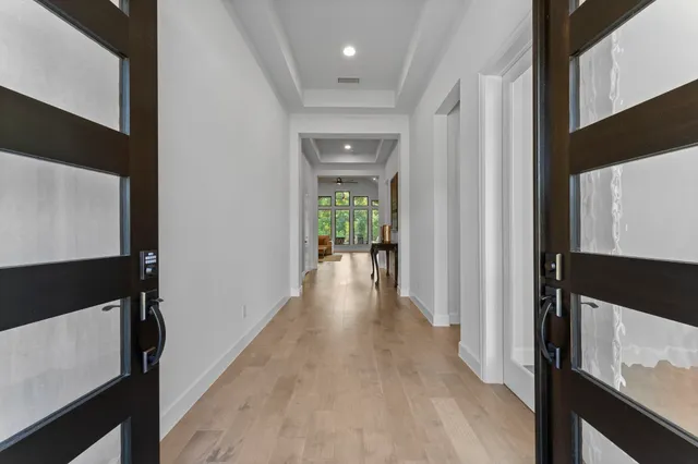 a view of hallway with wooden floor