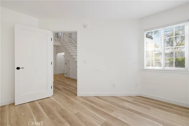 a view of a room with wooden floor and windows
