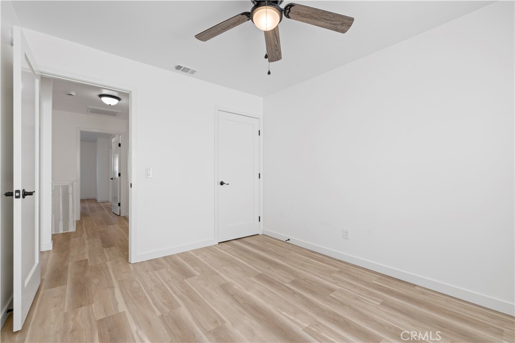 7049 Sunnycrest Trail Tujunga, CA 91042 - Photo 21 of 39 a view of a room with wooden floor and a ceiling fan