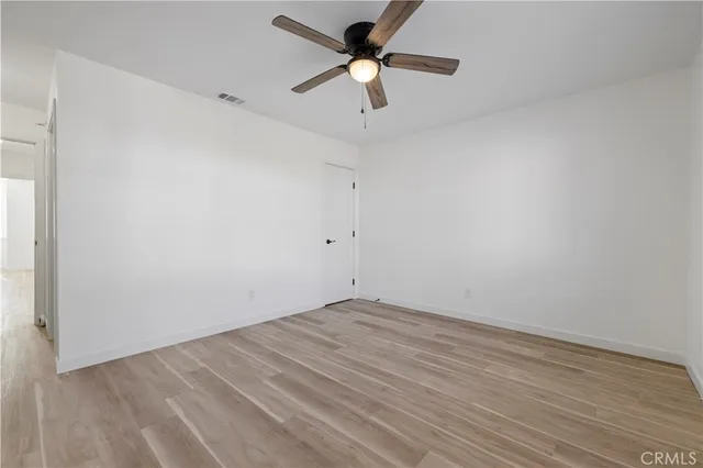 a view of an empty room with a ceiling fan