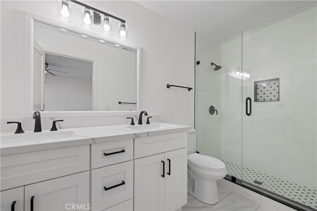 7049 Sunnycrest Trail Tujunga, CA 91042 - Photo 30 of 39 a bathroom with a toilet a sink a mirror a vanity and shower