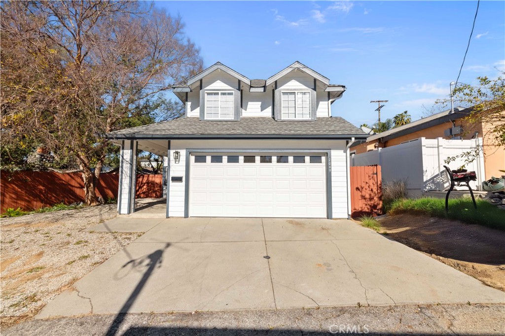 7049 Sunnycrest Trail Tujunga, CA 91042 - Photo 38 of 39 a front view of a house with a yard and garage
