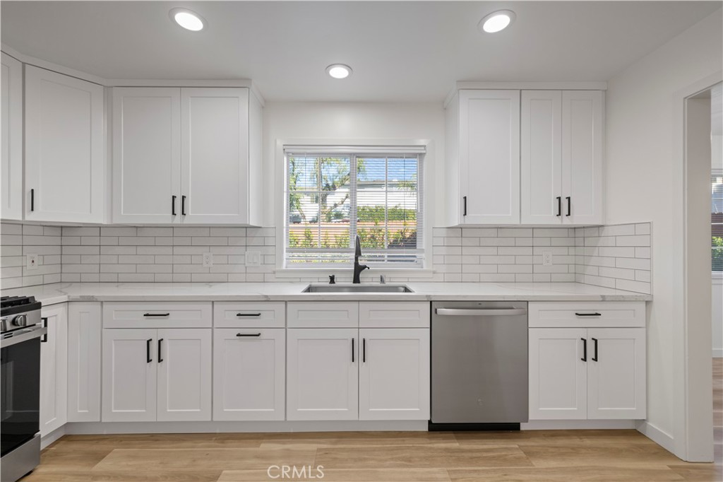 7049 Sunnycrest Trail Tujunga, CA 91042 - Photo 9 of 39 a kitchen with white cabinets white appliances sink and window