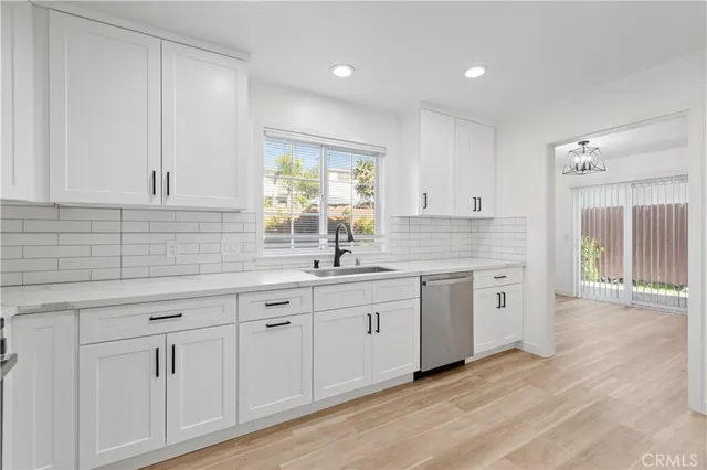 a kitchen with sink cabinets and wooden floor