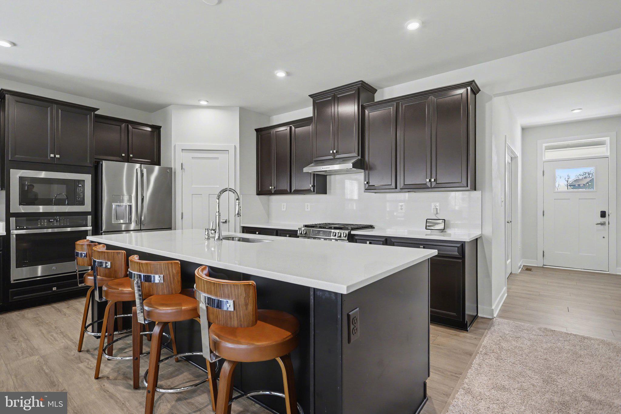 220 Kortney Drive Hanover, PA 17331 - Photo 12 of 41 a kitchen with stainless steel appliances a sink stove refrigerator and cabinets