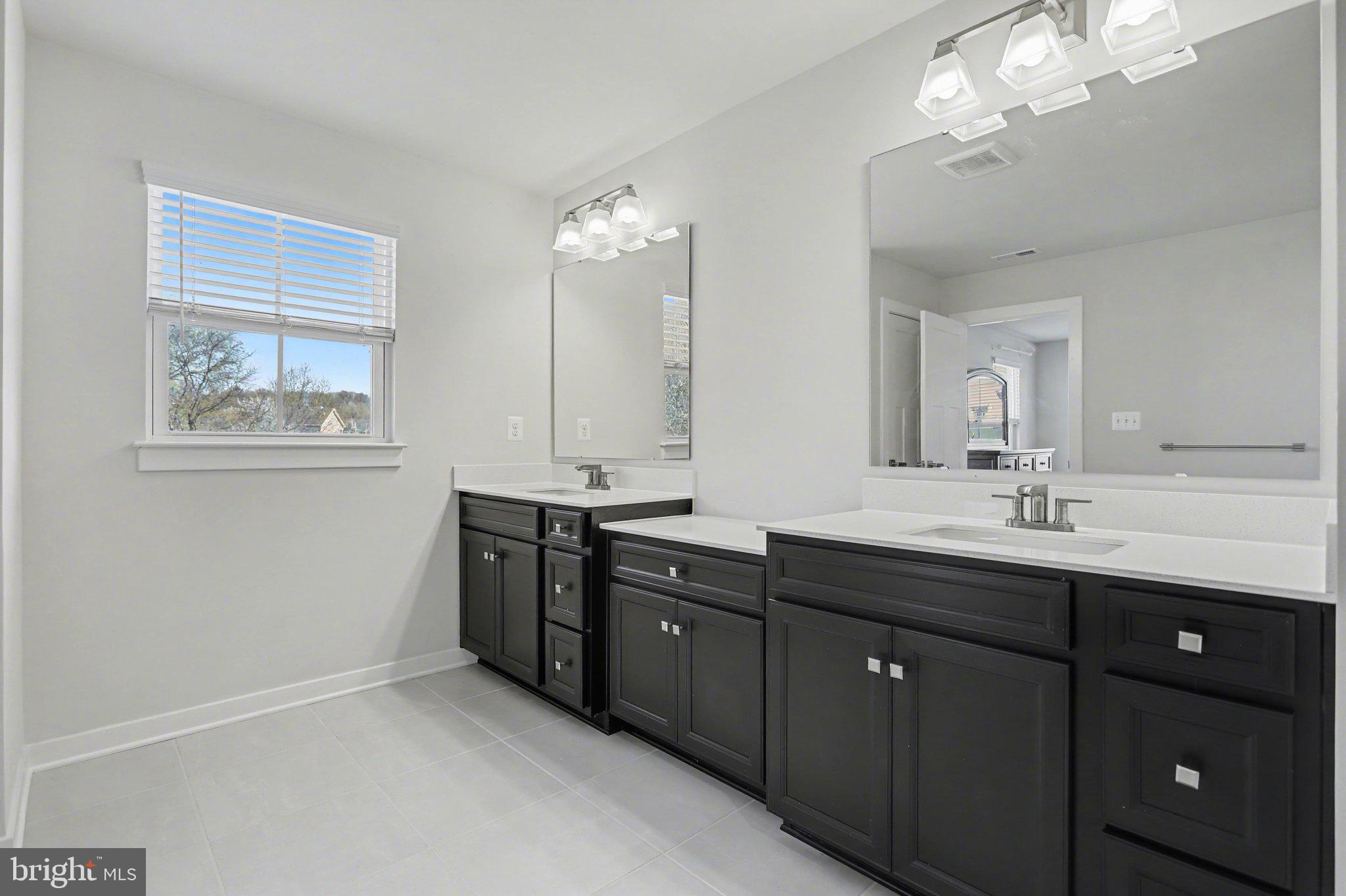 220 Kortney Drive Hanover, PA 17331 - Photo 21 of 41 a bathroom with double vanity sink a vanity a lamp and a window