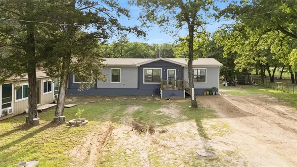 a view of a house with backyard porch and sitting area
