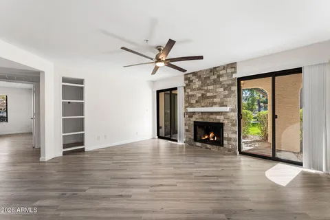 a view of an empty room with a fireplace and a window