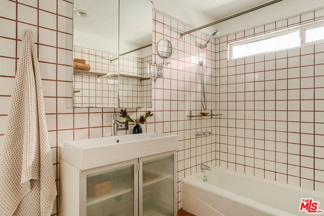 a view of a room with shelves and wooden floor