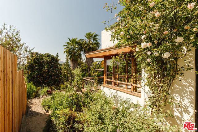 a kitchen with a sink and a stove with wooden floor
