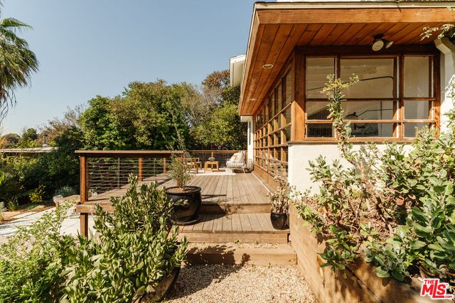 a kitchen with a large window and white appliances
