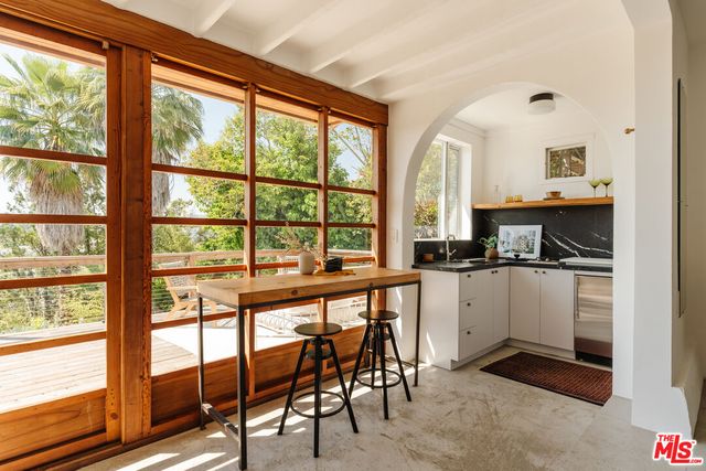 a view of a house with pool and sitting area