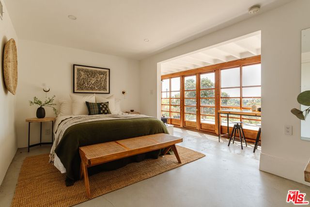 a view of a patio with table and chairs and potted plants