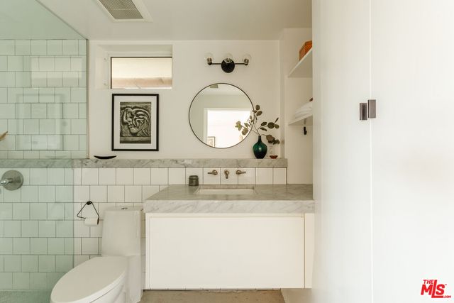 a view of a backyard with plants and tree